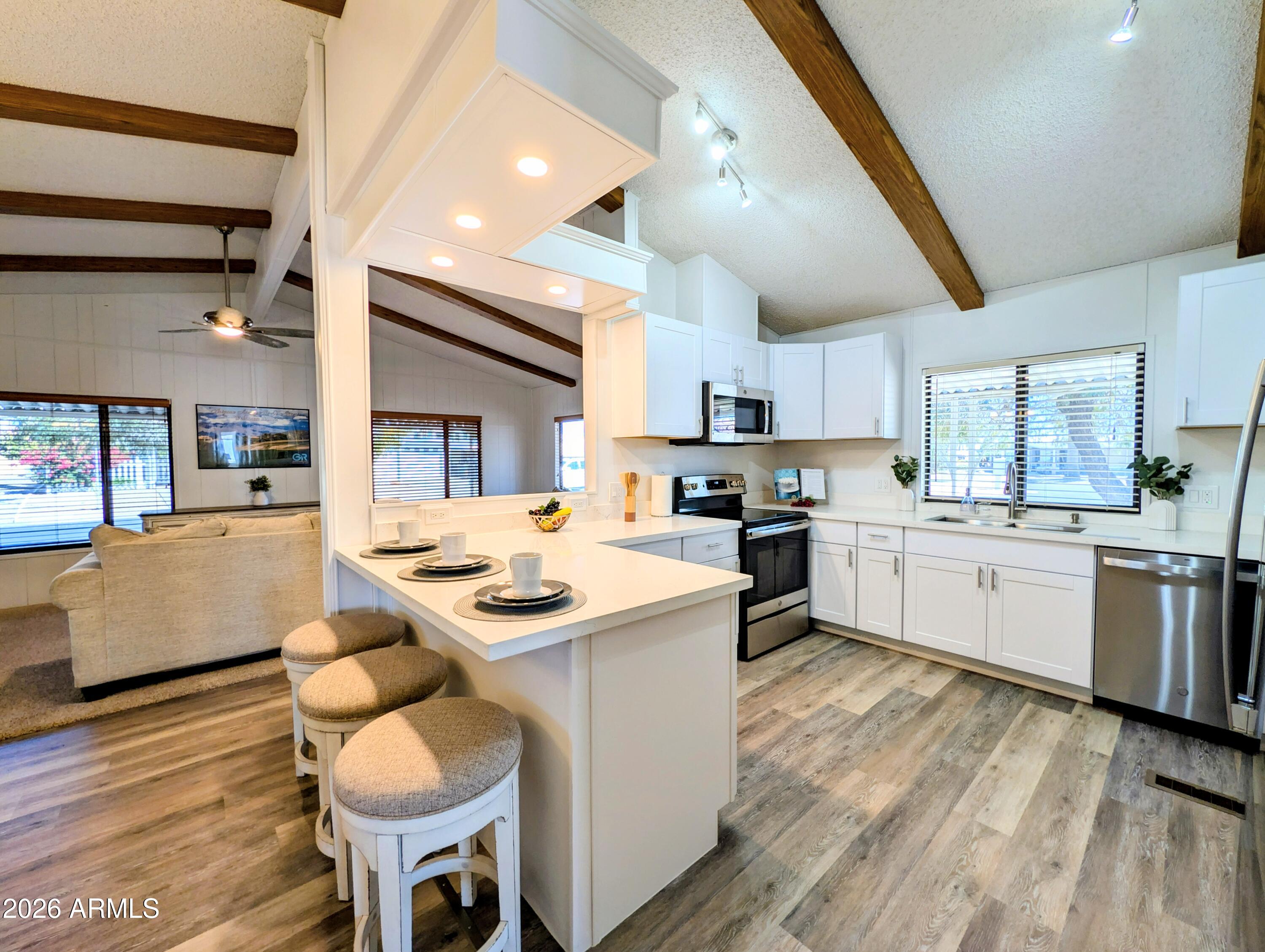 512 South 83rd Way Mesa, AZ 85208 - Photo 2 of 45 a kitchen with a sink a stove top oven and cabinets