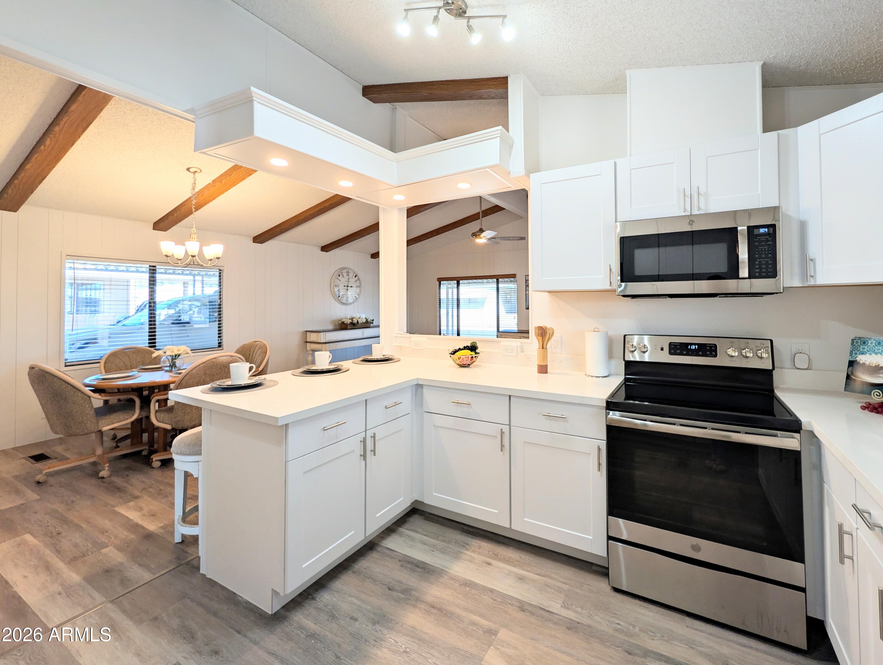 512 South 83rd Way Mesa, AZ 85208 - Photo 21 of 45 a kitchen with a stove and a microwave oven