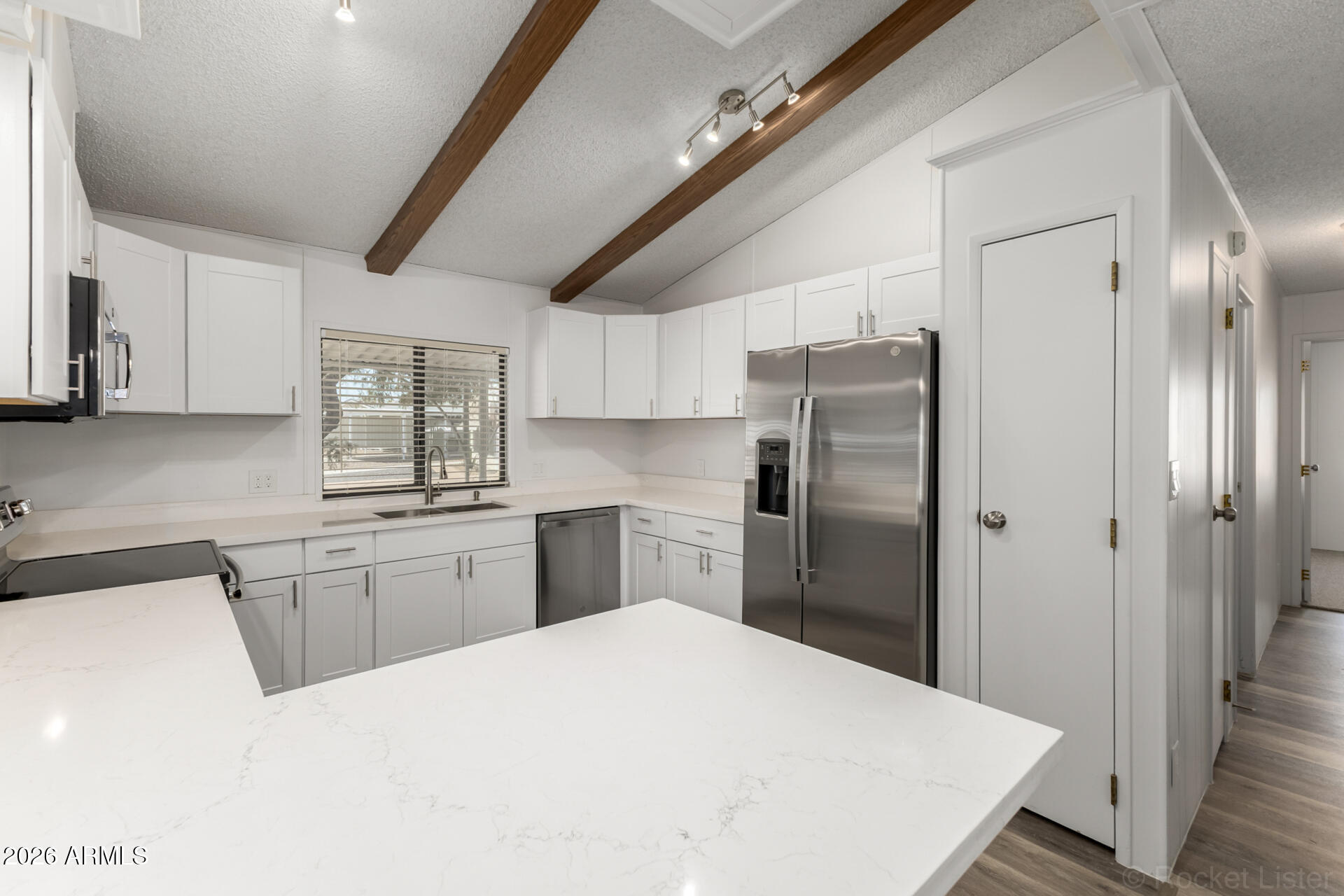 512 South 83rd Way Mesa, AZ 85208 - Photo 24 of 45 a kitchen with a refrigerator a sink a stove and cabinets