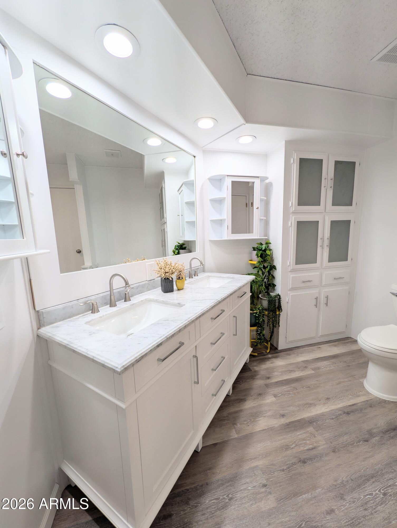 512 South 83rd Way Mesa, AZ 85208 - Photo 28 of 45 a spacious bathroom with a double vanity sink a large mirror and a toilet