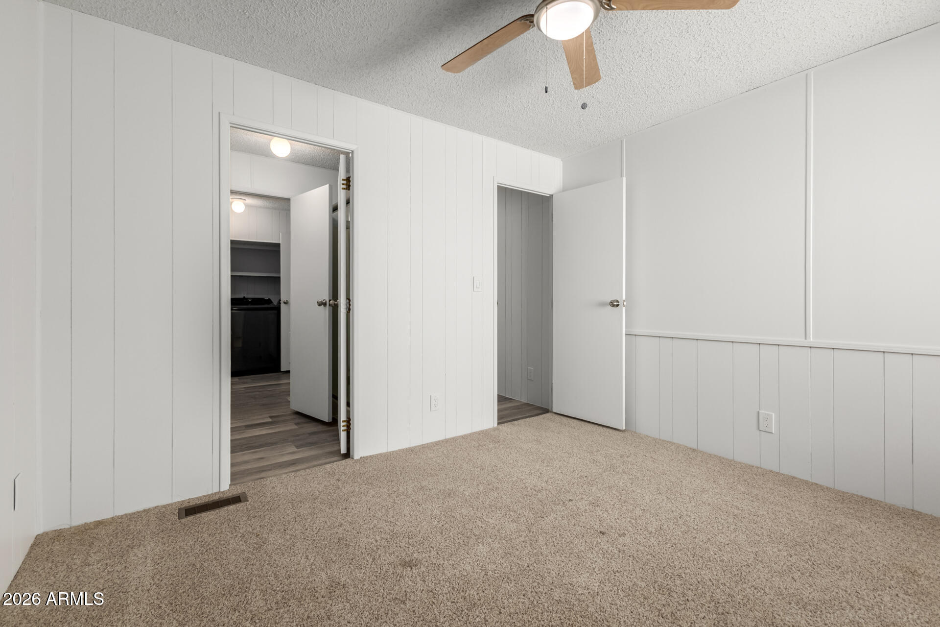 512 South 83rd Way Mesa, AZ 85208 - Photo 31 of 45 an empty room with closet and a chandelier fan