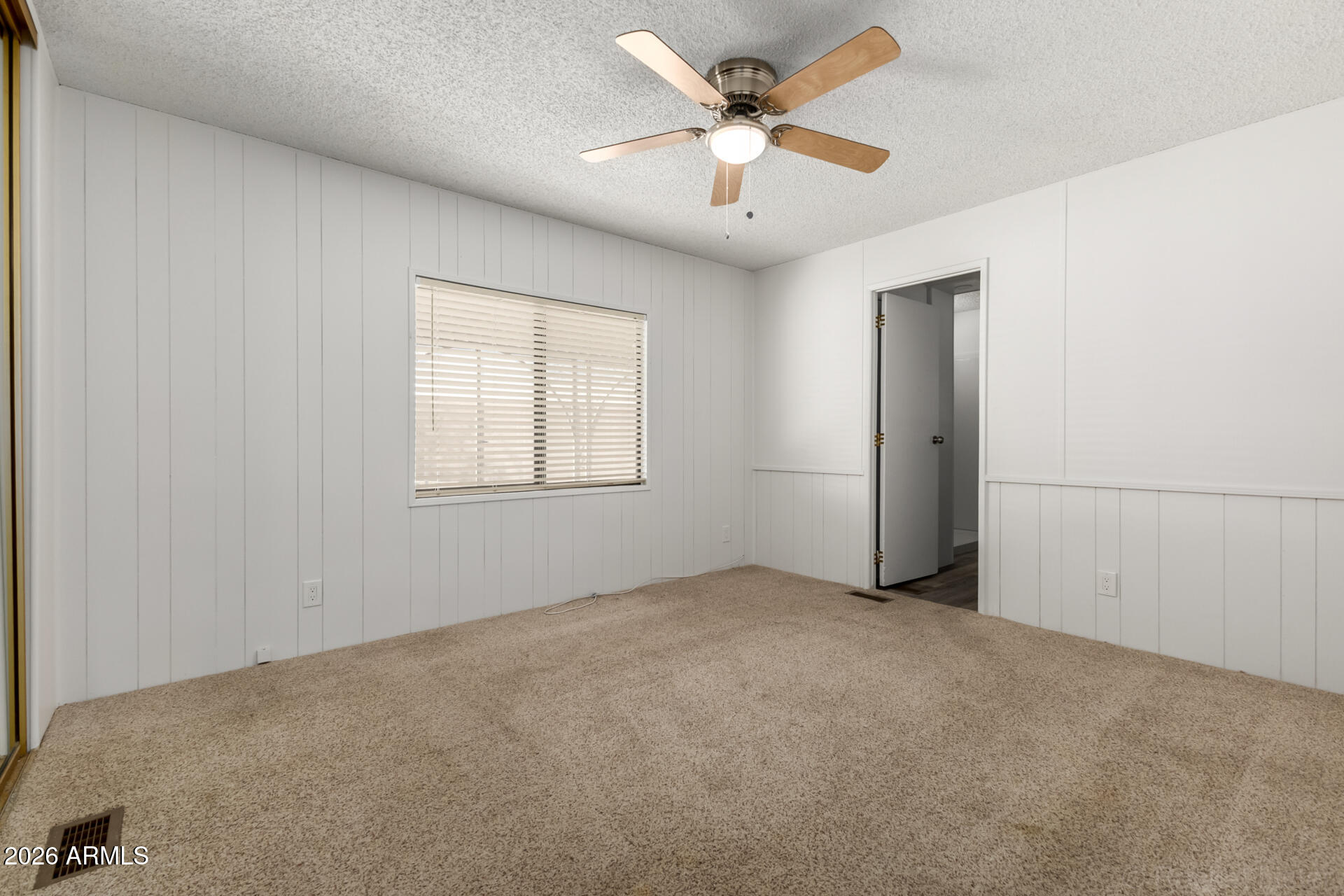 512 South 83rd Way Mesa, AZ 85208 - Photo 40 of 45 an empty room with fan and windows
