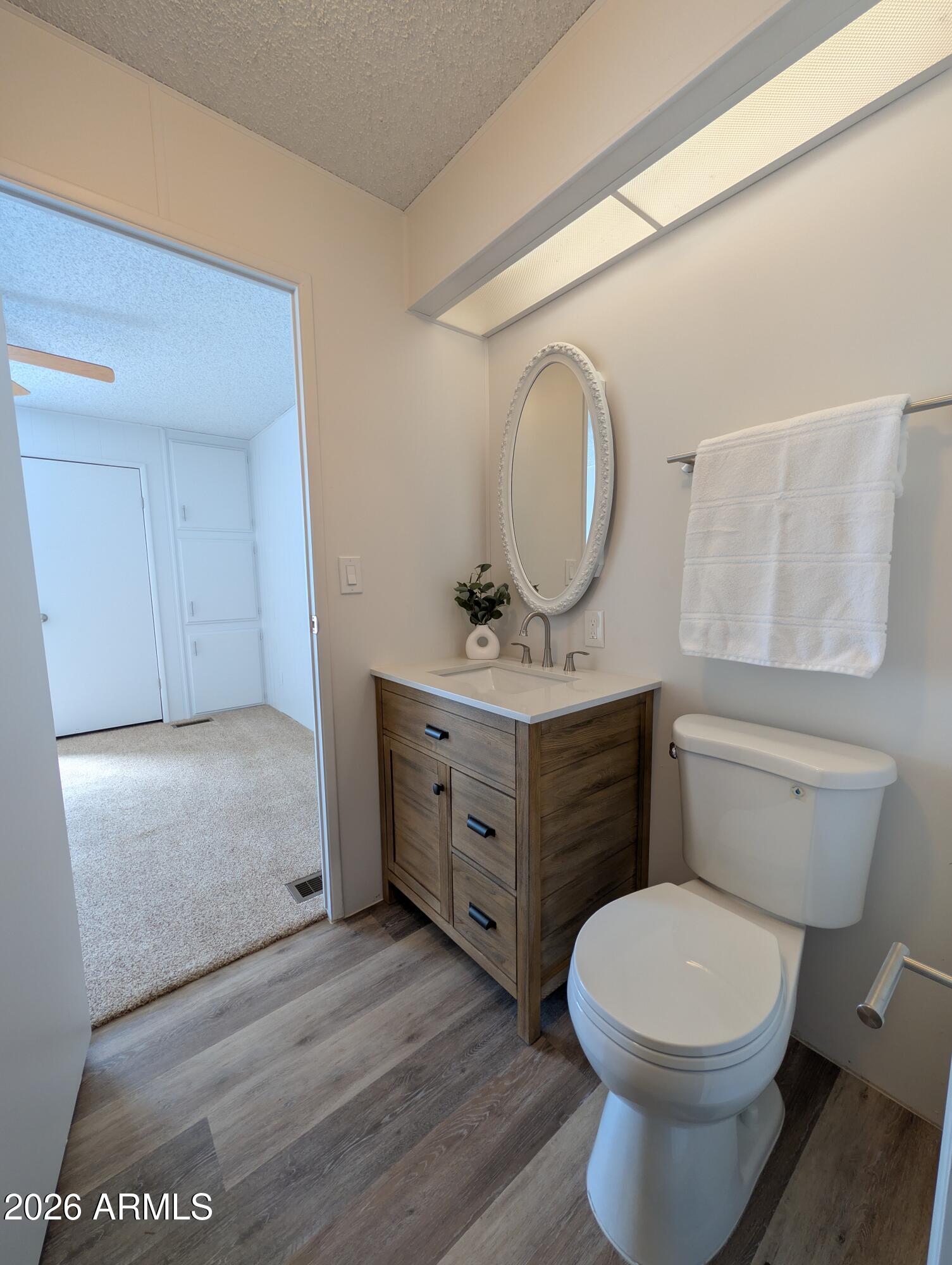 512 South 83rd Way Mesa, AZ 85208 - Photo 42 of 45 a bathroom with a toilet a sink a vanity and mirror