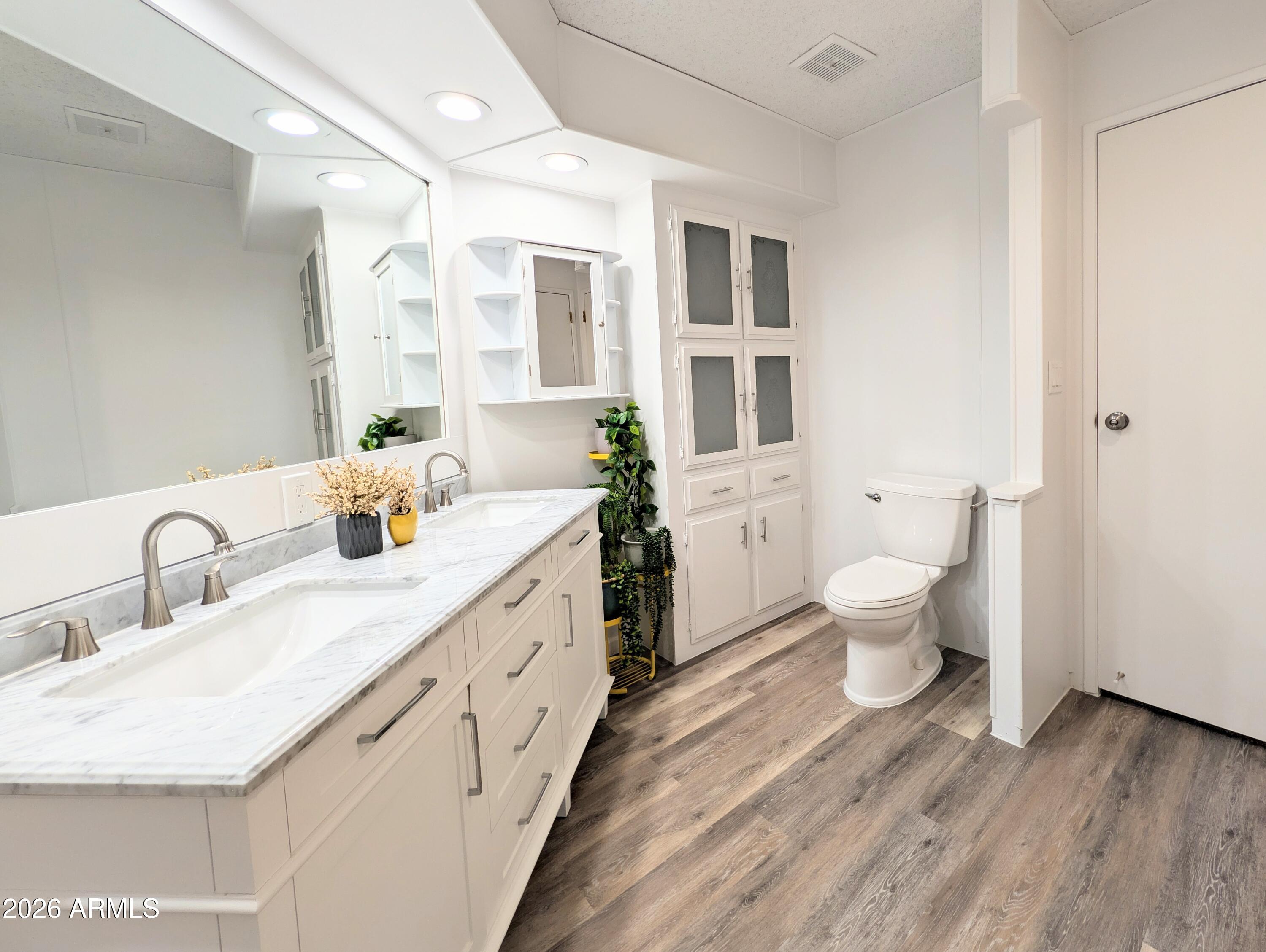 512 South 83rd Way Mesa, AZ 85208 - Photo 6 of 45 a spacious bathroom with a double vanity sink a mirror and a toilet