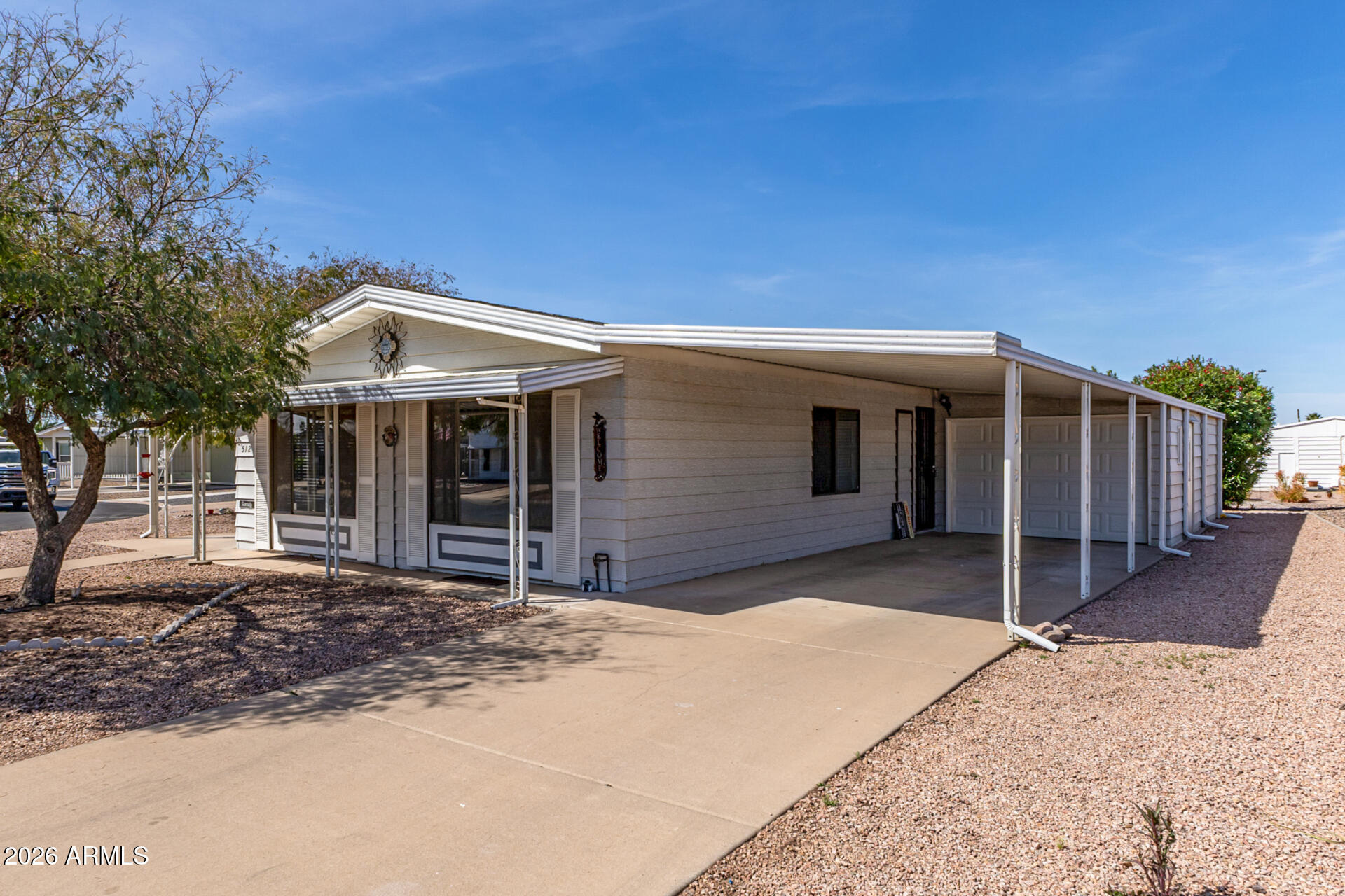 512 South 83rd Way Mesa, AZ 85208 - Photo 9 of 45 a front view of a house with a yard and garage
