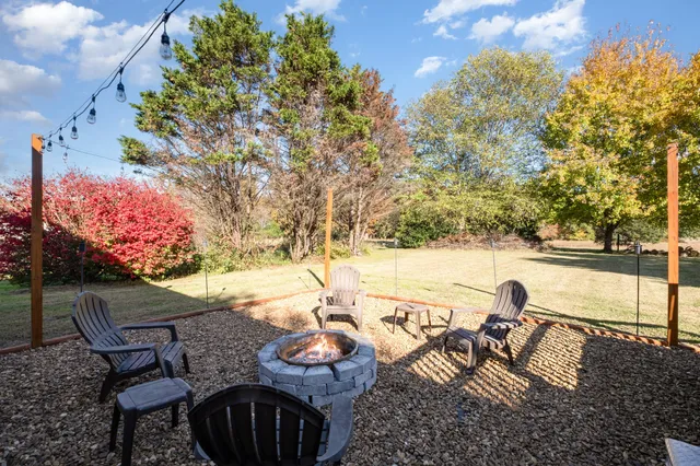 a view of a lake with furniture and a yard
