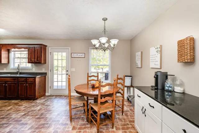 a large kitchen with a table and chairs in it
