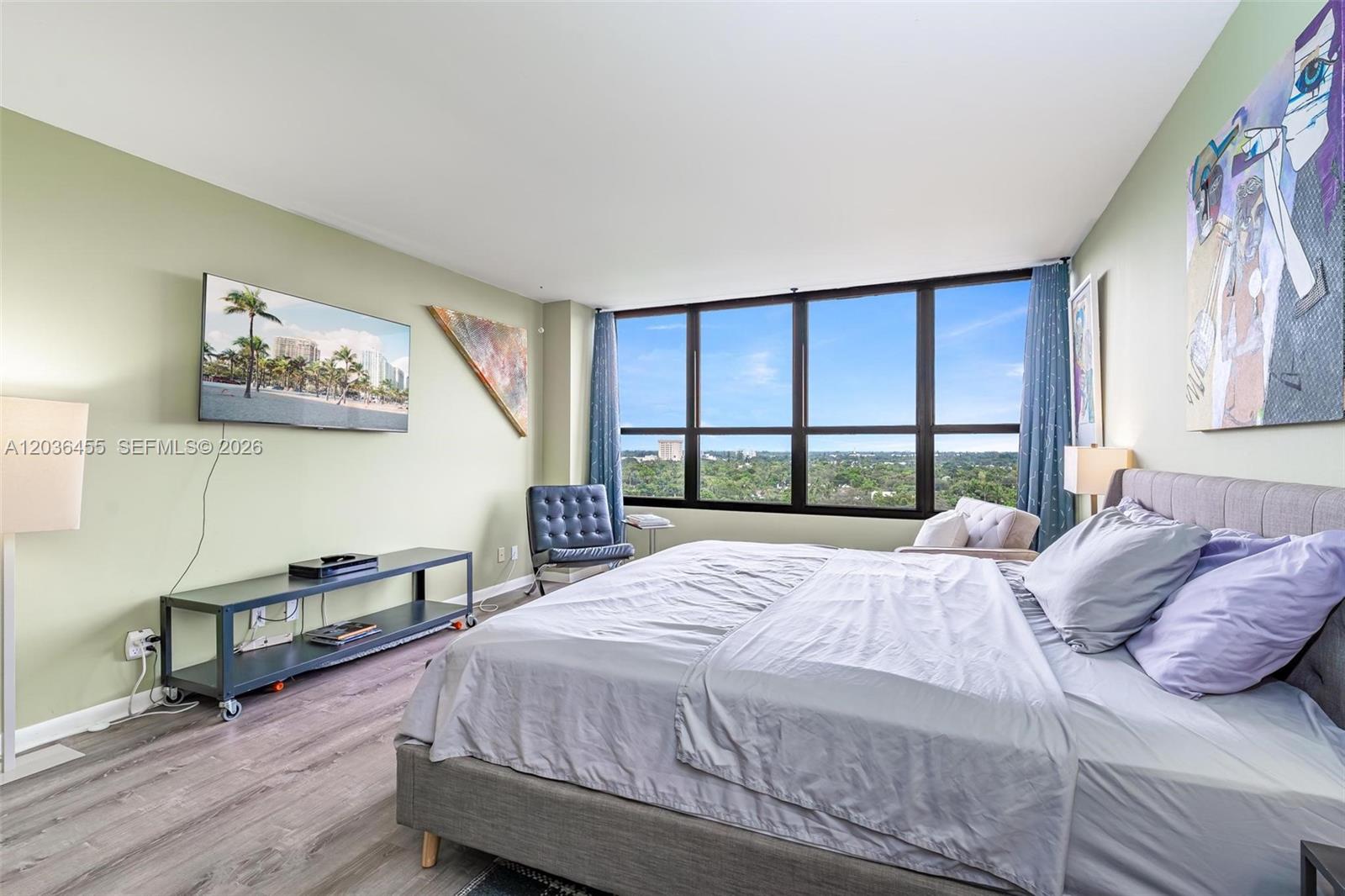 780 Northeast 69th Street, Unit 1010 Miami, FL 33138 - Photo 24 of 31 a bedroom with a bed a table and a large window