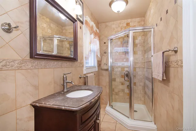 a bathroom with a granite countertop sink mirror and shower