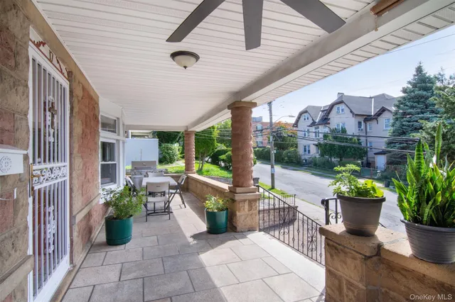 a building outdoor space with patio furniture and potted plants