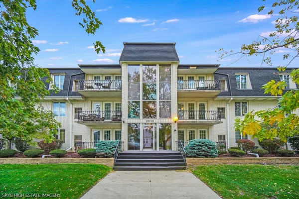 a front view of a residential apartment building with a yard