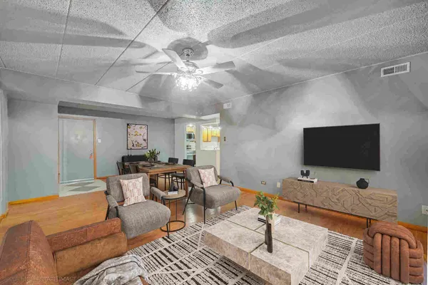 a living room with furniture and a flat screen tv