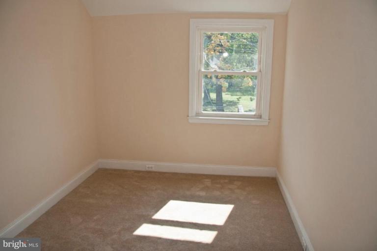 1303 Crofton Road Baltimore, MD 21239 - Photo 11 of 17 an empty room with a window