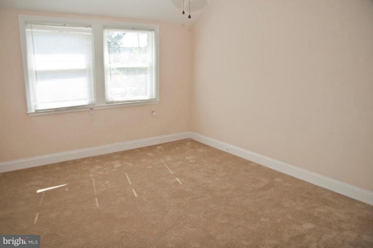 1303 Crofton Road Baltimore, MD 21239 - Photo 12 of 17 an empty room with a window