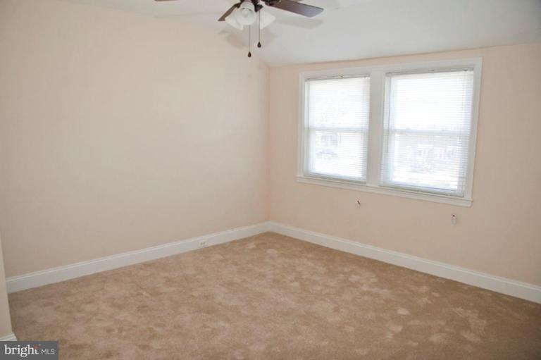 1303 Crofton Road Baltimore, MD 21239 - Photo 14 of 17 an empty room with a window