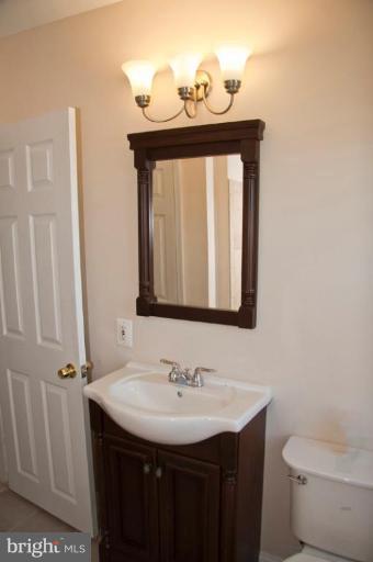 1303 Crofton Road Baltimore, MD 21239 - Photo 15 of 17 a bathroom with a sink and a toilet