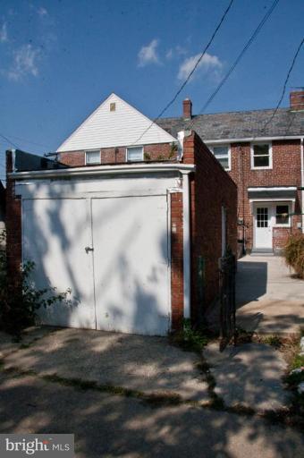 1303 Crofton Road Baltimore, MD 21239 - Photo 16 of 17 a front view of a house with a yard