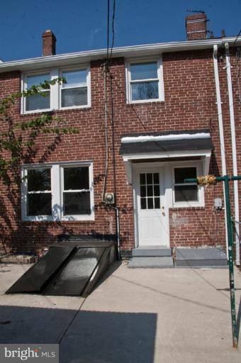 1303 Crofton Road Baltimore, MD 21239 - Photo 17 of 17 a view of house and car parked