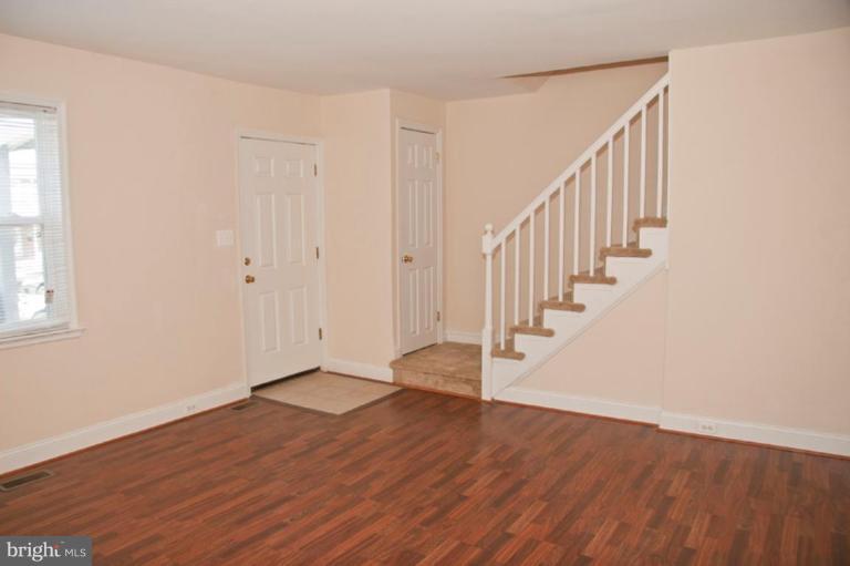 1303 Crofton Road Baltimore, MD 21239 - Photo 3 of 17 a view of an entryway with wooden floor