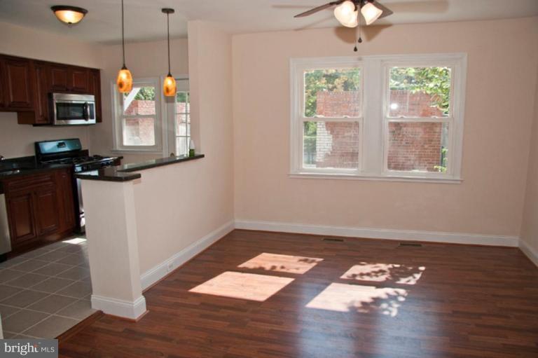 1303 Crofton Road Baltimore, MD 21239 - Photo 5 of 17 a very nice looking room with wooden floor and a chandelier
