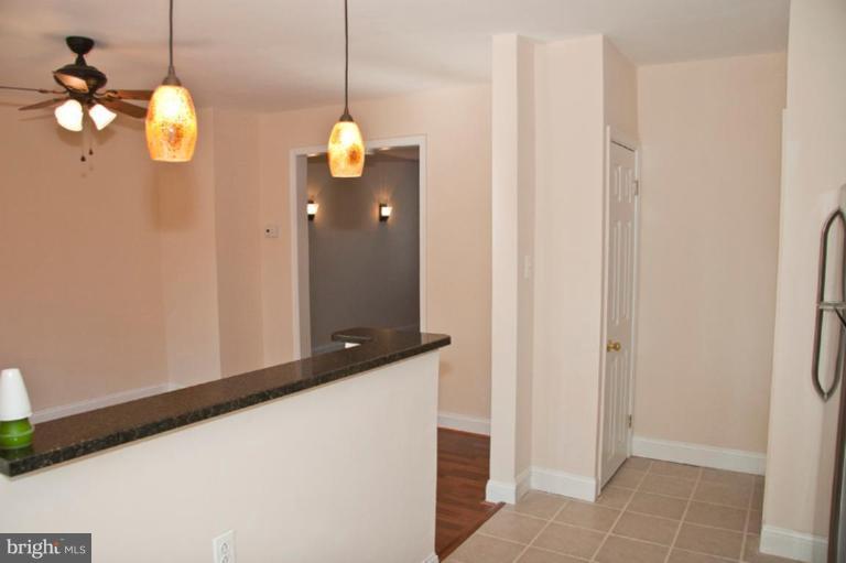 1303 Crofton Road Baltimore, MD 21239 - Photo 7 of 17 a view of a hallway with chandelier
