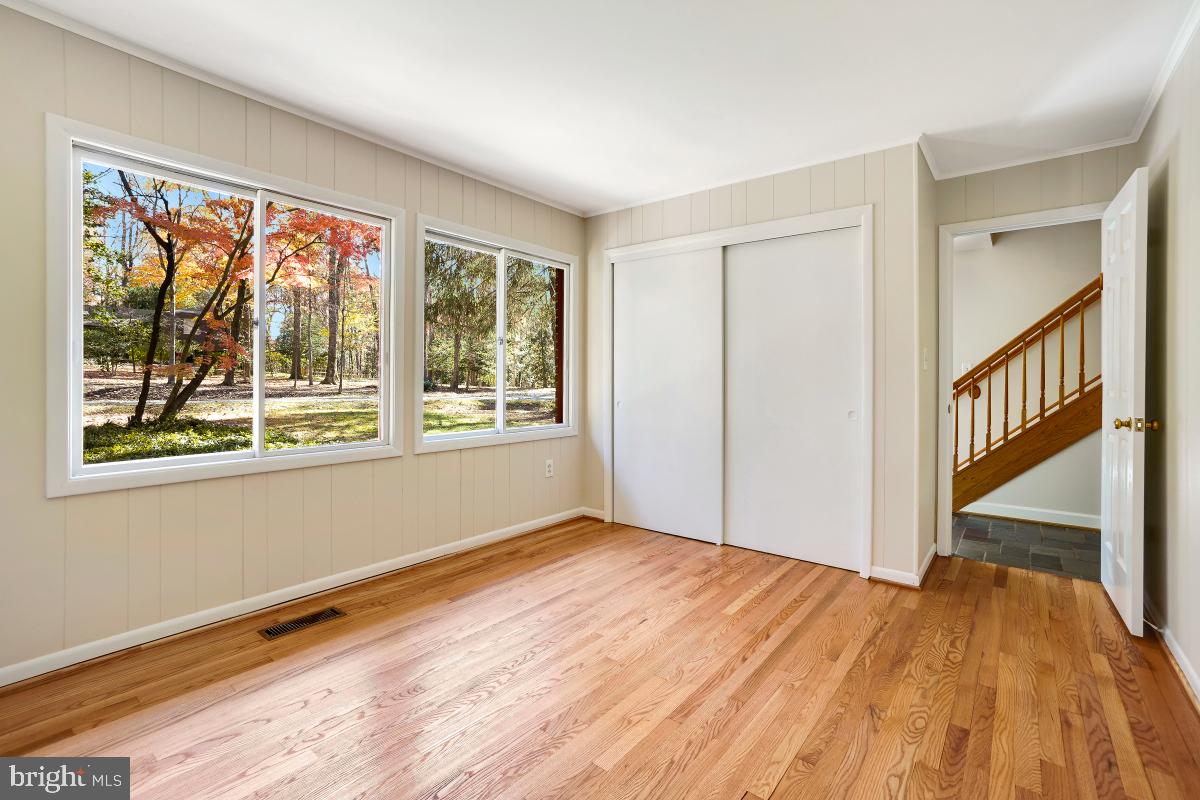2606 Deerdell Lane Reston, VA 20191 - Photo 21 of 49 a view of an empty room with wooden floor and a window