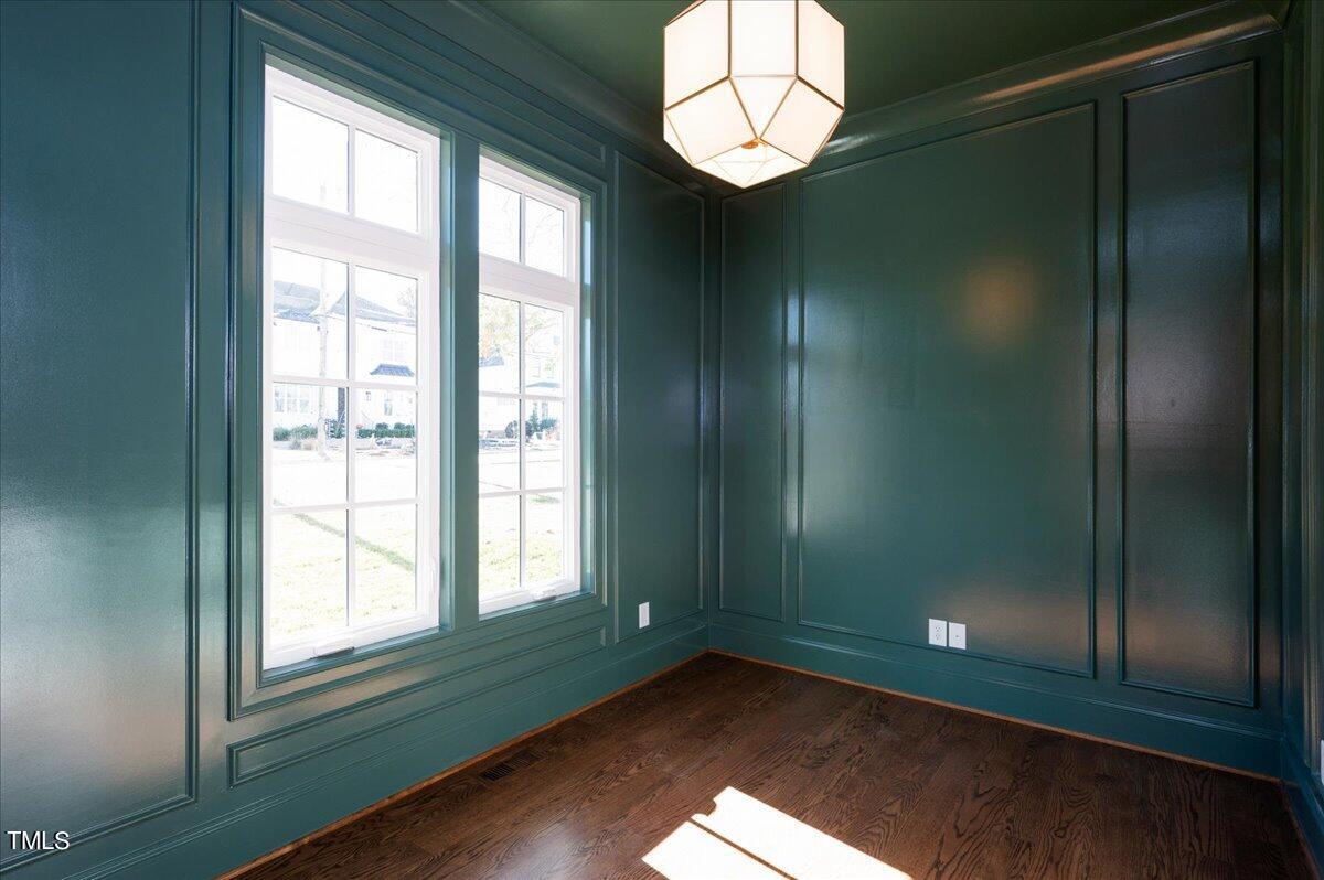 705 Mills Street Raleigh, NC 27608 - Photo 4 of 23 a view of empty room with wooden floor and fan