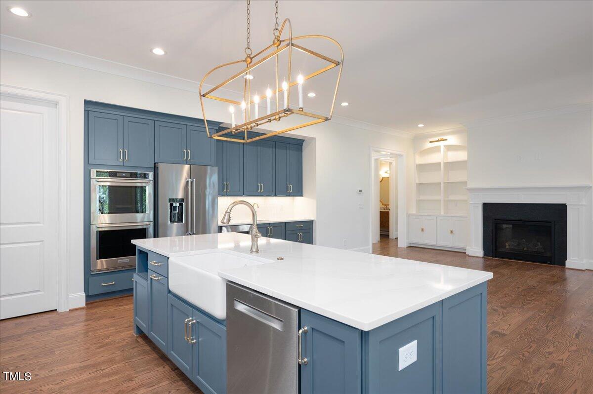 705 Mills Street Raleigh, NC 27608 - Photo 7 of 23 a kitchen with kitchen island a sink stainless steel appliances and cabinets