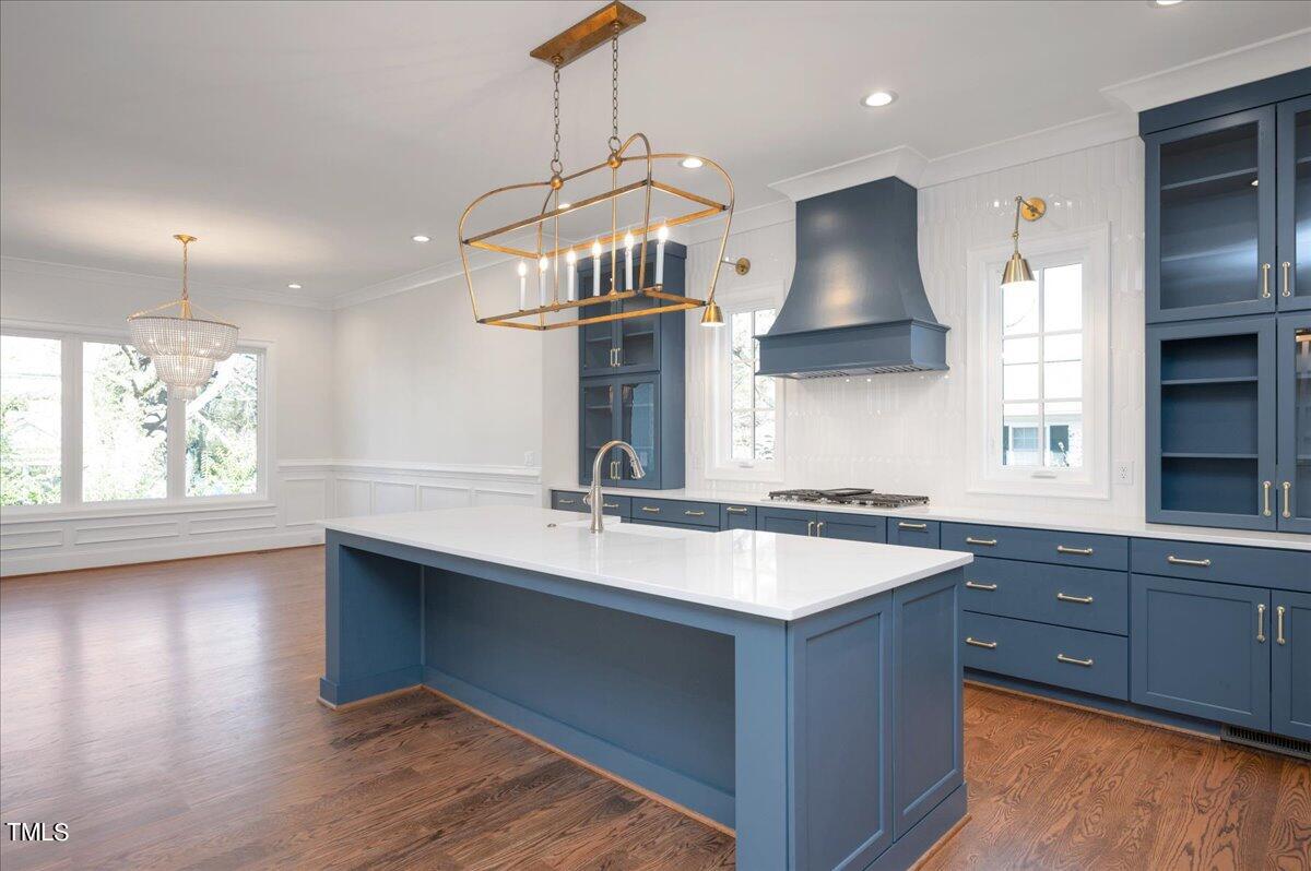 705 Mills Street Raleigh, NC 27608 - Photo 9 of 23 a kitchen with stainless steel appliances granite countertop a sink a stove and a wooden floors