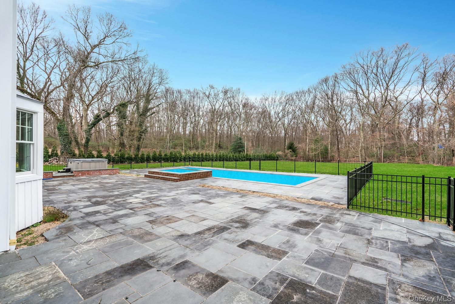 539 Split Rock Road Syosset, NY 11791 - Photo 37 of 40 View of pool with a hot tub, a lawn, fence, and a patio