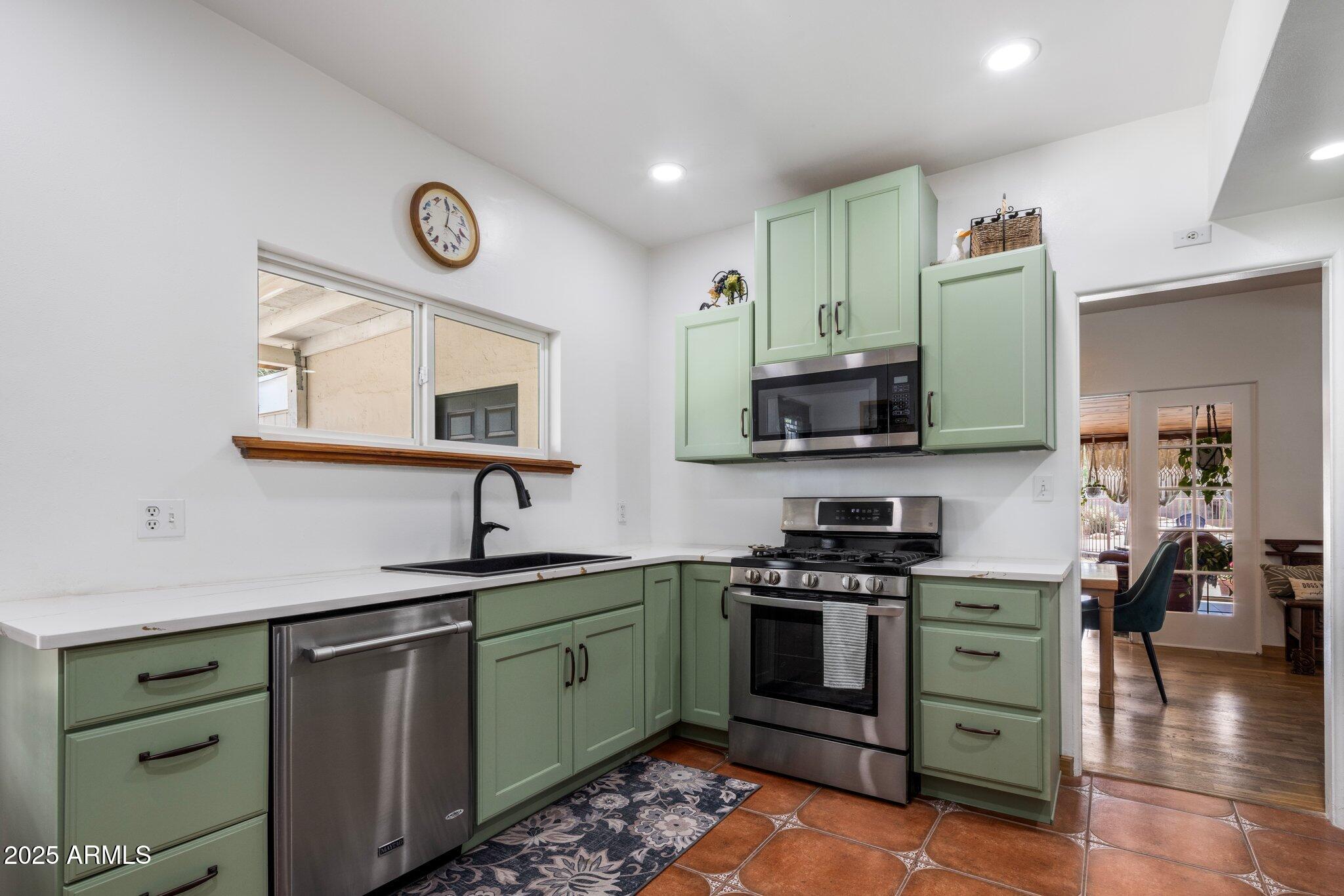 55 East Pierson Street Phoenix, AZ 85012 - Photo 10 of 26 a kitchen with cabinets and stainless steel appliances