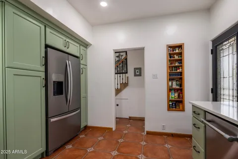a view of kitchen with cabinets and window