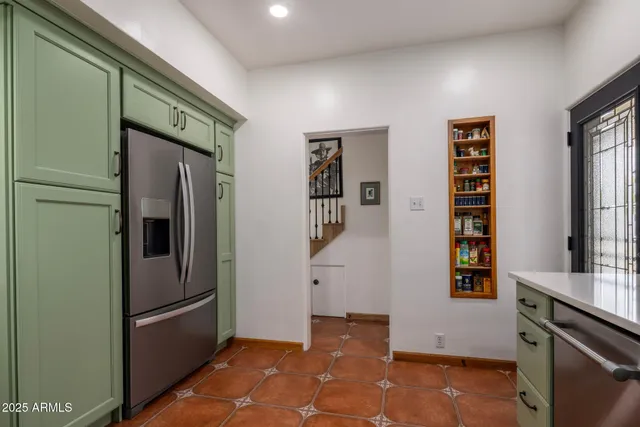a view of kitchen with cabinets and window