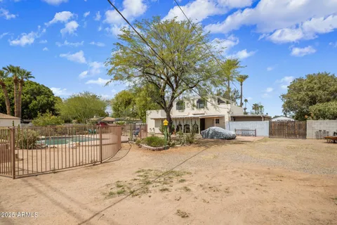 a view of a house with a wooden fence