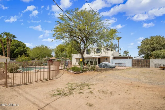 a view of a house with a wooden fence