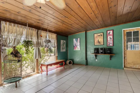 a bedroom with furniture and a large window