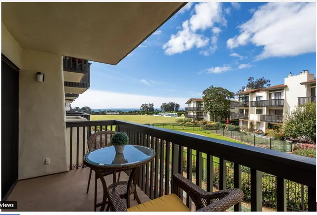 a view of a balcony with mountain view and wooden floor