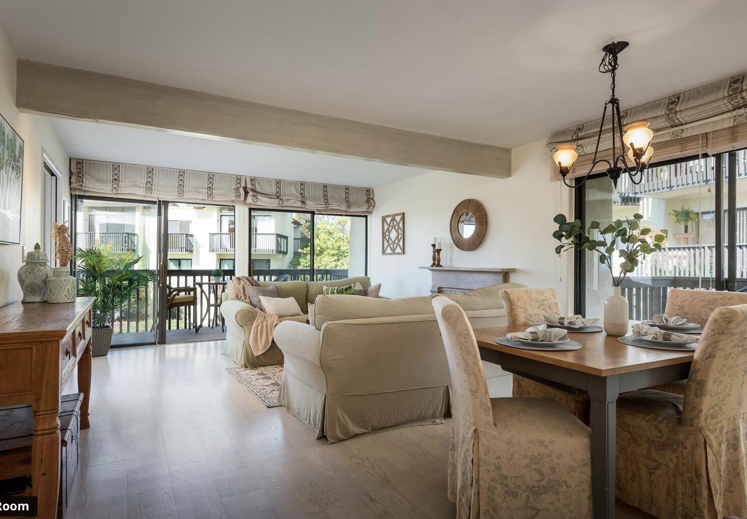 3375 Foothill Road, Unit 624 Carpinteria, CA 93013 - Photo 6 of 14 a living room with furniture a chandelier and a large window