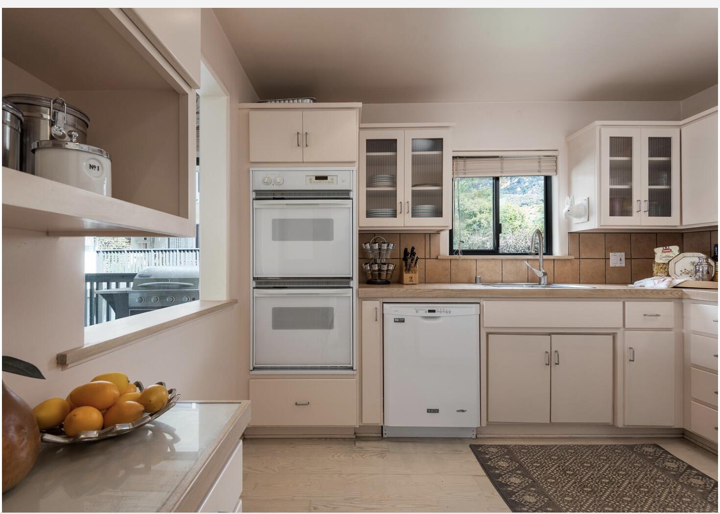 3375 Foothill Road, Unit 624 Carpinteria, CA 93013 - Photo 8 of 14 a kitchen with white cabinets and window