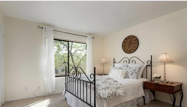 a bedroom with a bed and a window