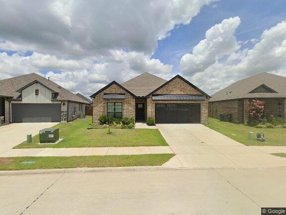 469 Waters Rdg Drive Lavon, TX 75166 - Photo 1 of 1 Brick exterior with dark trim accents, attached garage, concrete driveway, and a landscaped front yard