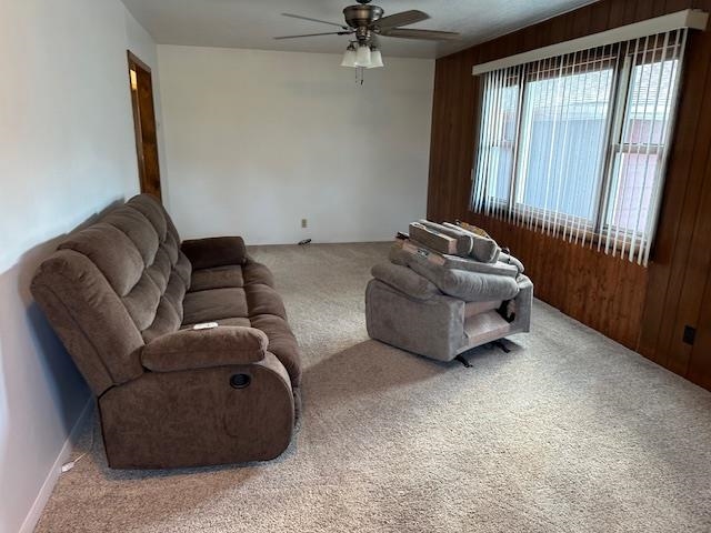 30 Fir Circle Babbitt, MN 55706 - Photo 11 of 27 Living area featuring carpet floors, wood walls, and ceiling fan