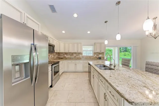 a kitchen with a sink and refrigerator