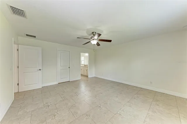 a view of a livingroom with a ceiling fan and window