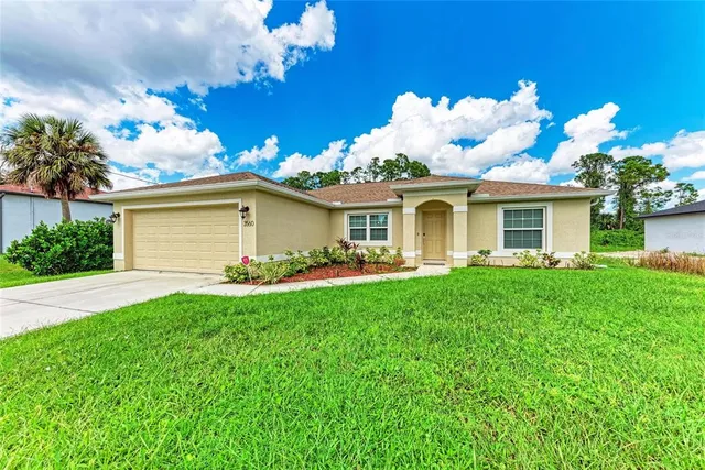 a view of a house with a backyard