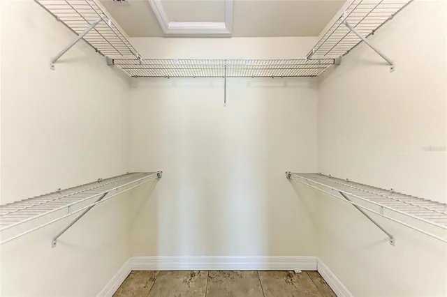 a bathroom with a granite countertop double vanity sink mirror and toilet