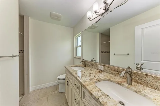 a bathroom with a glass shower door