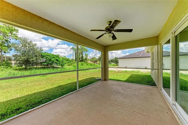 a view of a room with a large window and front door