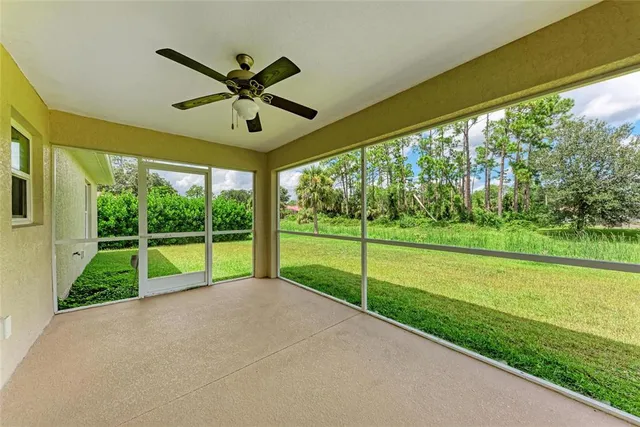 a view of a house with a big yard and large trees