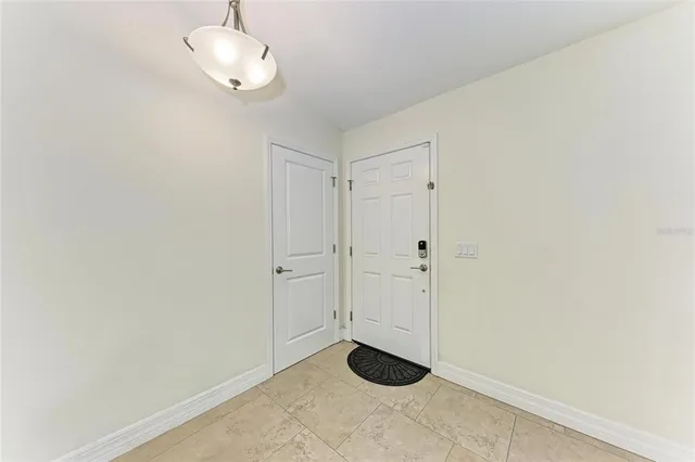 a view of a livingroom with a fireplace a ceiling fan and wooden floor